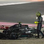 Lewis Hamilton stands beside his crashed car in the gravel at the Qatar Grand Prix