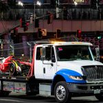The Ferrari car of Carlos Sainz is taken away on a truck after being damaged by a drain cover on the Las Vegas circuit.
