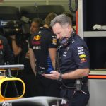 Christian Horner looking at his mobile phone in the team garage at F1 practice today in Bahrain