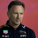 Red Bull team principal Christian Horner listens to a question during a news conference.