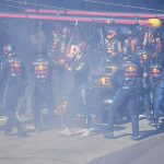 Verstappen (centre) is pictured getting out of his Red Bull after the pit crew battled flames coming from the right rear brake